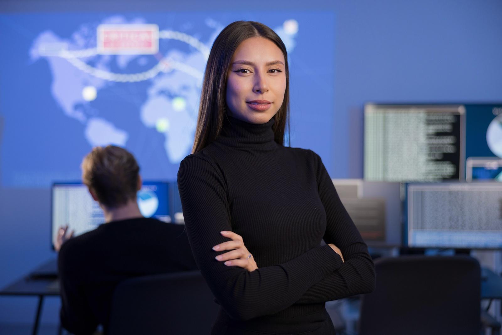 A security analyst monitoring alerts across digital displays